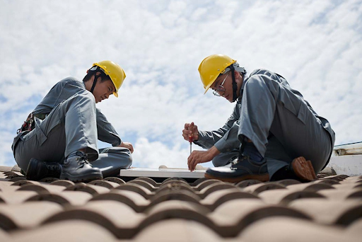 Union Roofing technician inspecting a residential roof for winter wind damage in Philadelphia.