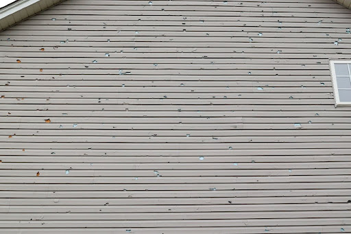 Storm damage on home siding after heavy wind and rain