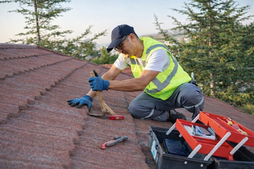Roofing professional inspecting roof surface during post-storm assessment