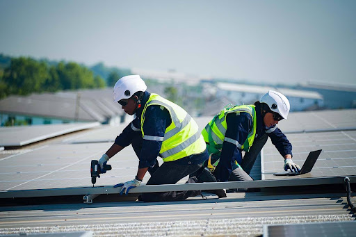 Union Roofing crew heat-welding TPO seams on a commercial building.